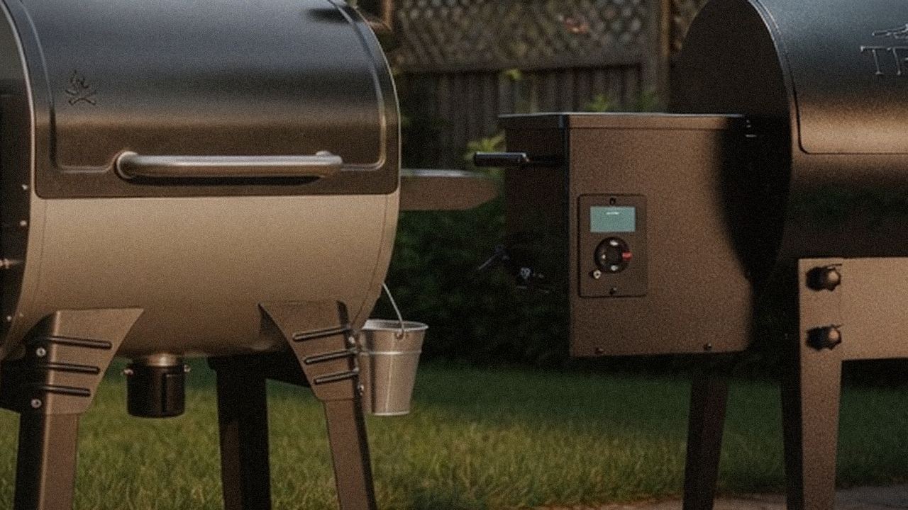 Close comparison of the Camp Chef Woodwind WiFi 24 controller next to the Traeger Tailgater 20 controller