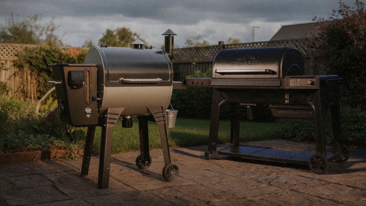 Camp Chef Woodwind Pro WiFi 24 beside Traeger Timberline, editorial product photography