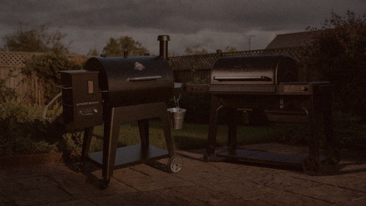 Pit Boss Navigator 850 and Traeger Woodridge Pro at night with smoke, wood pellet grills on a dark patio