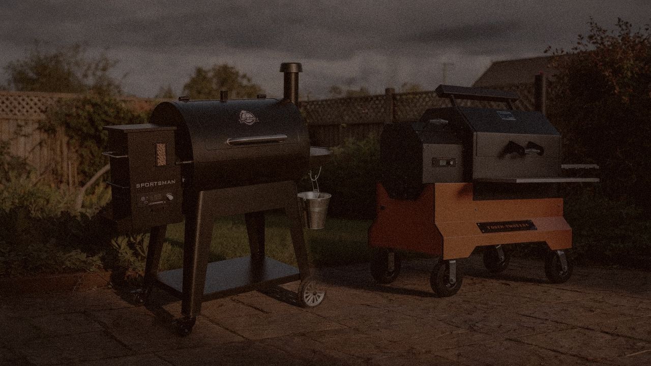 Pit Boss Navigator 850 and Yoder Smokers YS640s at night with smoke, wood pellet grills on a dark patio