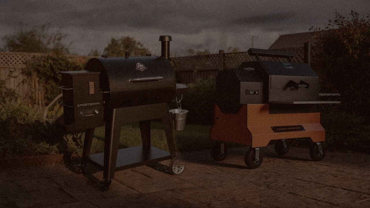 Pit Boss Sportsman and Yoder Smokers YS640s at night with smoke, wood pellet grills on a dark patio
