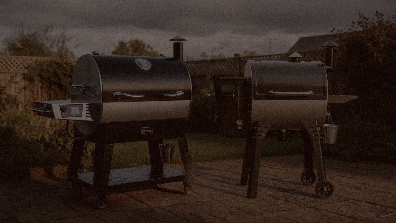 recteq Flagship 1600 and Camp Chef Woodwind Pro WiFi 24 at night with smoke, wood pellet grills on a dark patio