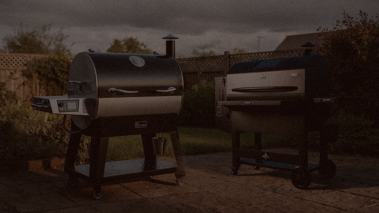 recteq Flagship 1600 and Green Mountain Grills Peak at night with smoke, wood pellet grills on a dark patio