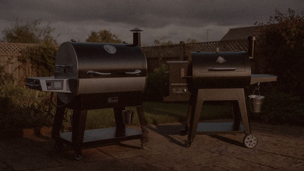 recteq Flagship 1600 and Pit Boss Navigator 850 at night with smoke, wood pellet grills on a dark patio