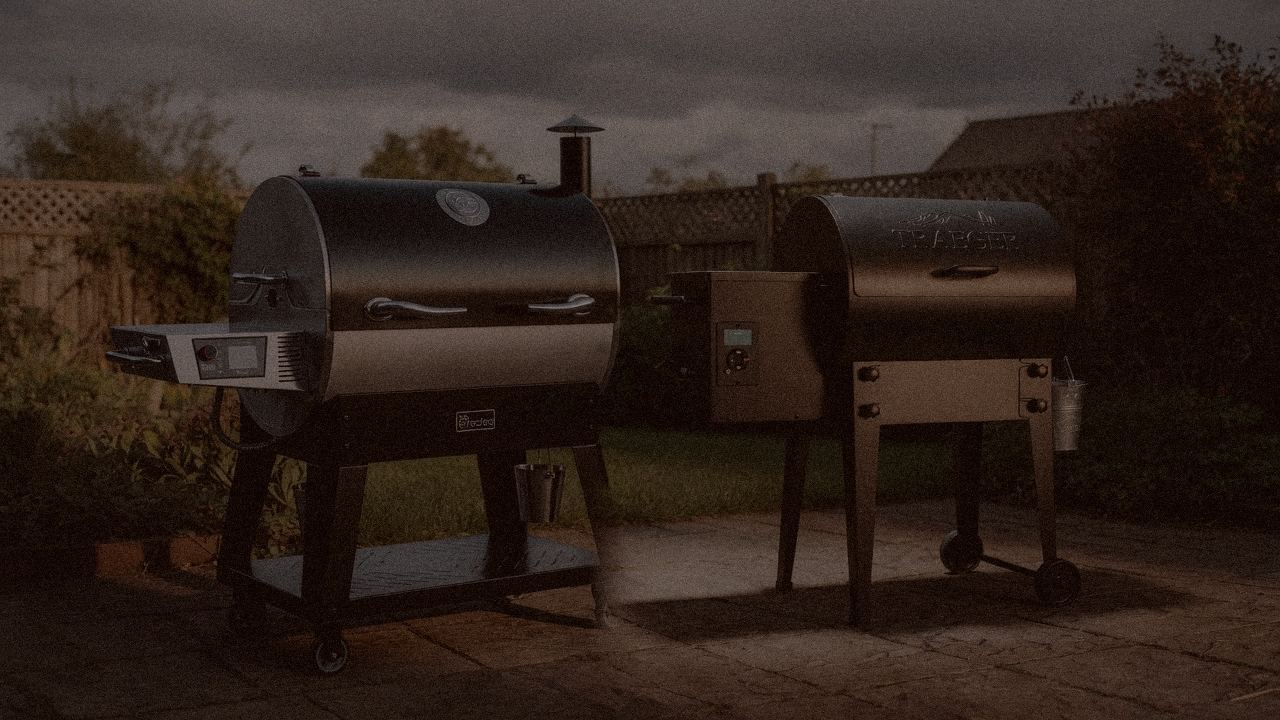 recteq Flagship 1600 and Traeger Tailgater 20 at night with smoke, wood pellet grills on a dark patio