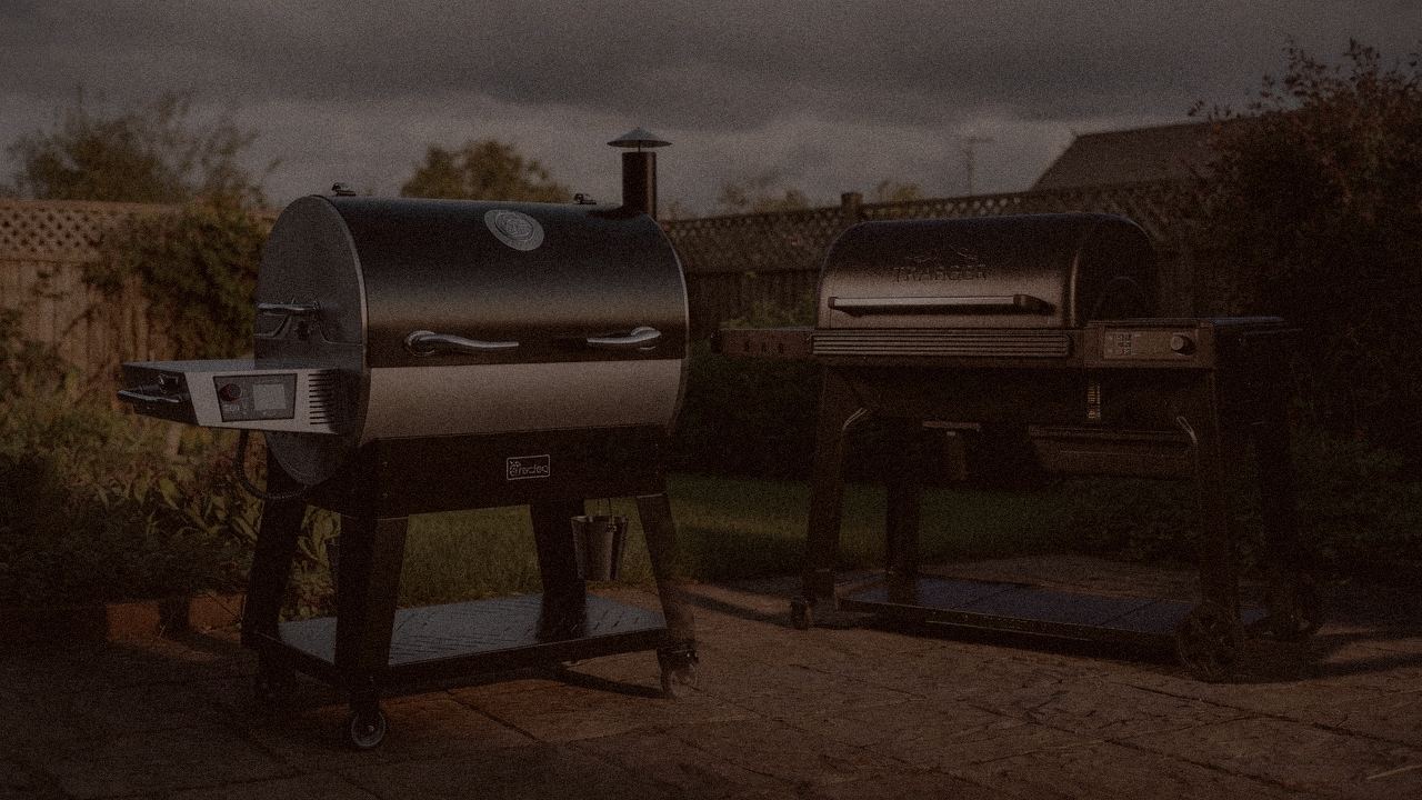 recteq Flagship 1600 and Traeger Timberline at night with smoke, wood pellet grills on a dark patio