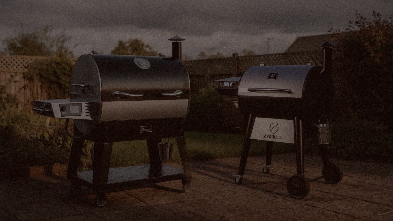 recteq Flagship 1600 and Z Grills 700 Series (ZPG-7002) at night with smoke, wood pellet grills on a dark patio