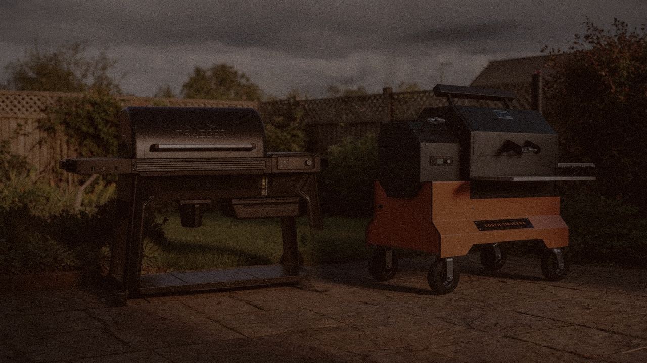 Traeger Pro 780 and Yoder Smokers YS640s at night with smoke, wood pellet grills on a dark patio
