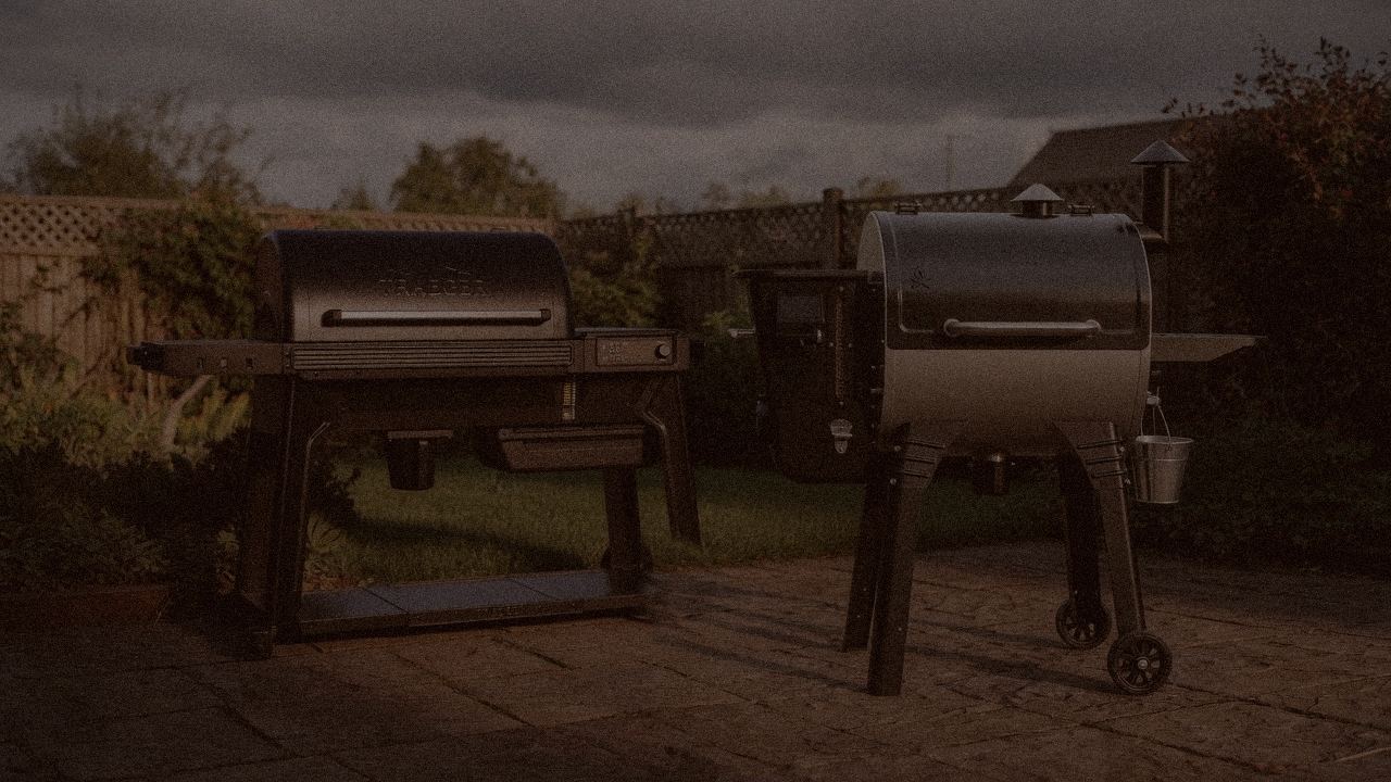 Traeger Woodridge Pro versus Camp Chef Woodwind Pro on a dusk patio