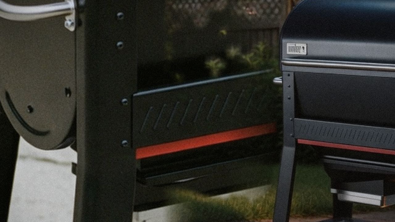 Weber Searwood 600 beside Weber Searwood XL 600, official product photography on a dark steel panel